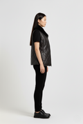 Side profile of Maverick Isabelle quilted vest showing sleeveless armhole cut and slim hip-length silhouette. Maverick Jacket.