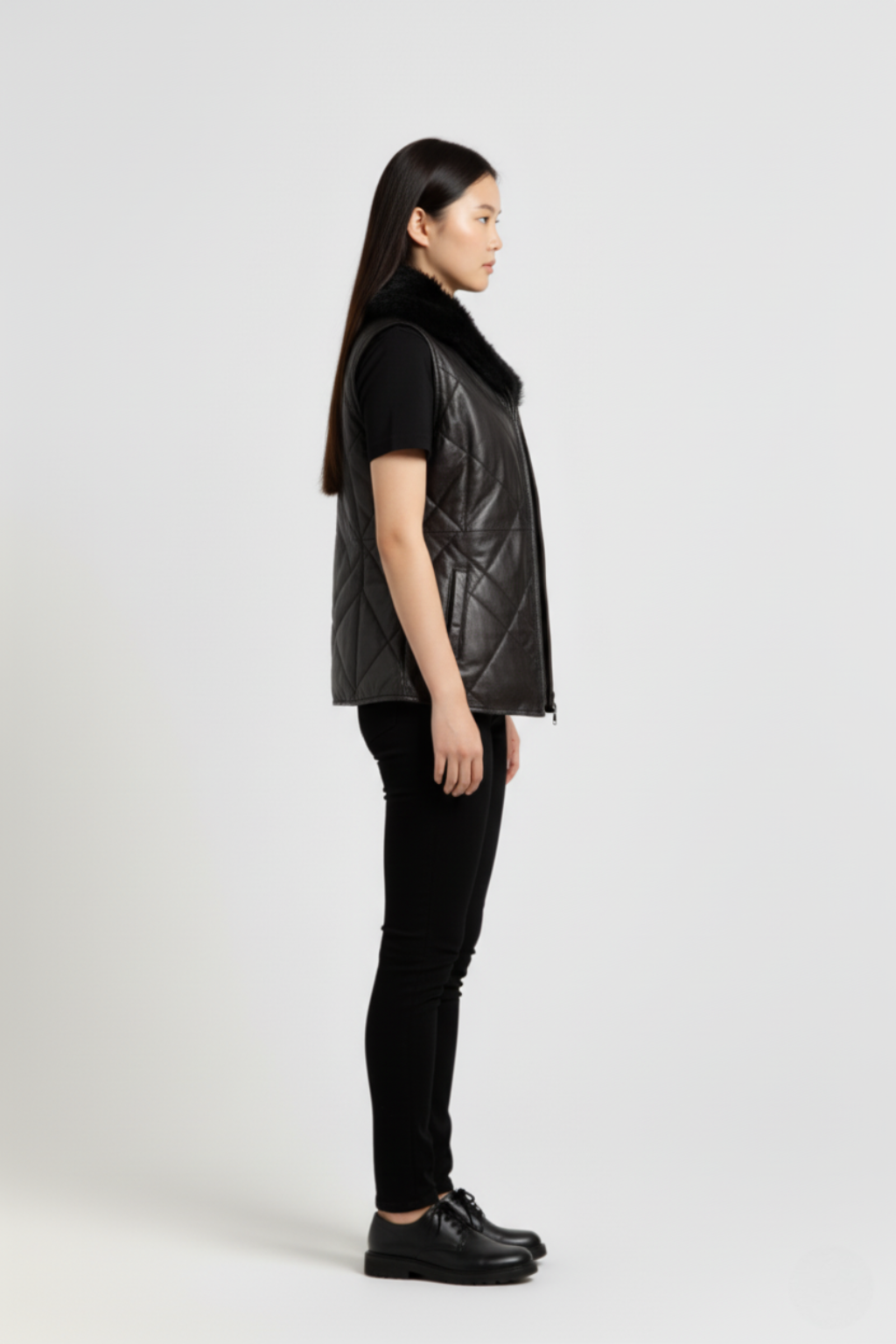 Side profile of Maverick Isabelle quilted vest showing sleeveless armhole cut and slim hip-length silhouette. Maverick Jacket.