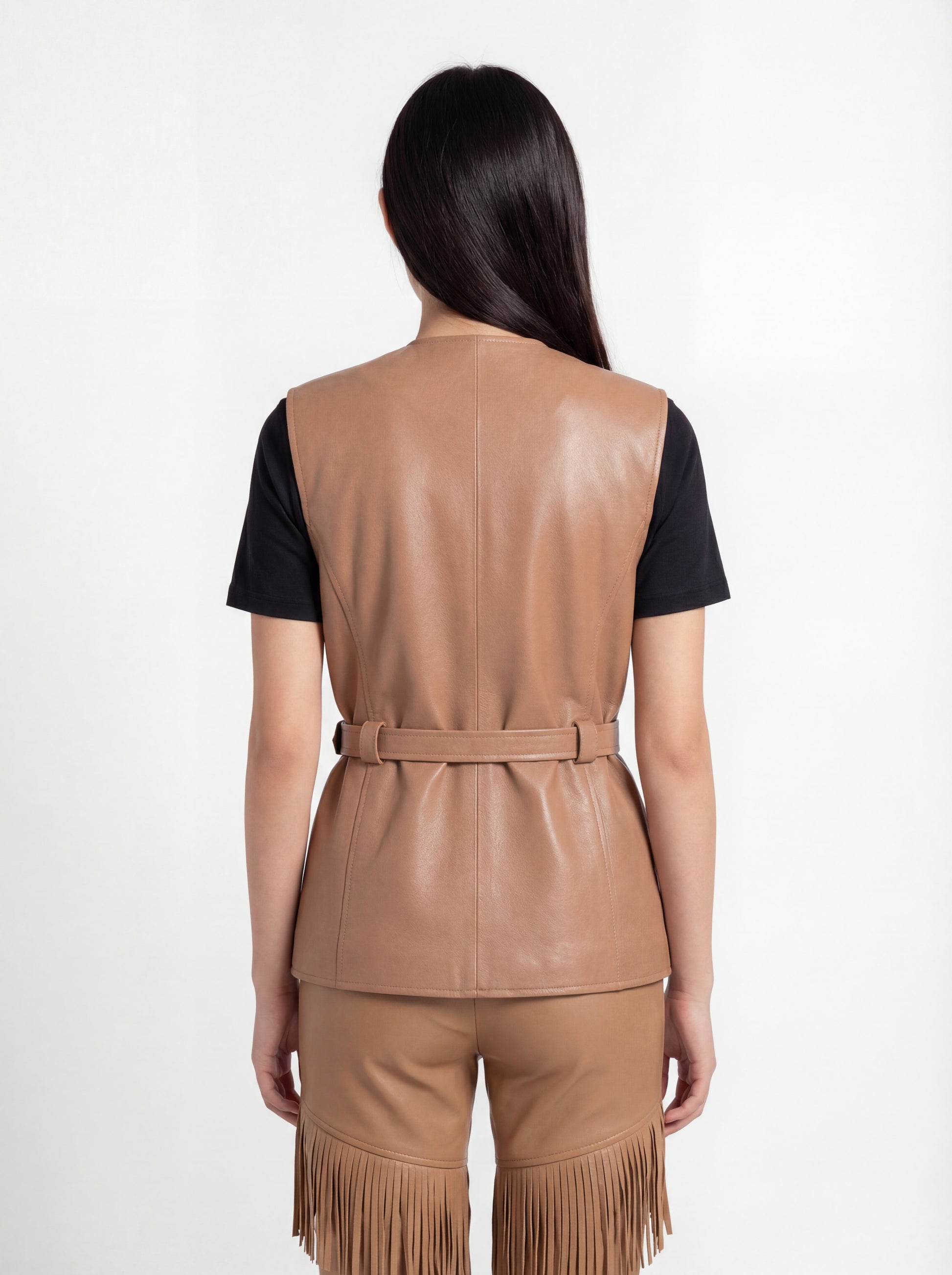 Rear view of female model wearing Maverick Victoria utility vest showing sleek back fit and belted waist styling. Maverick Jacket.
