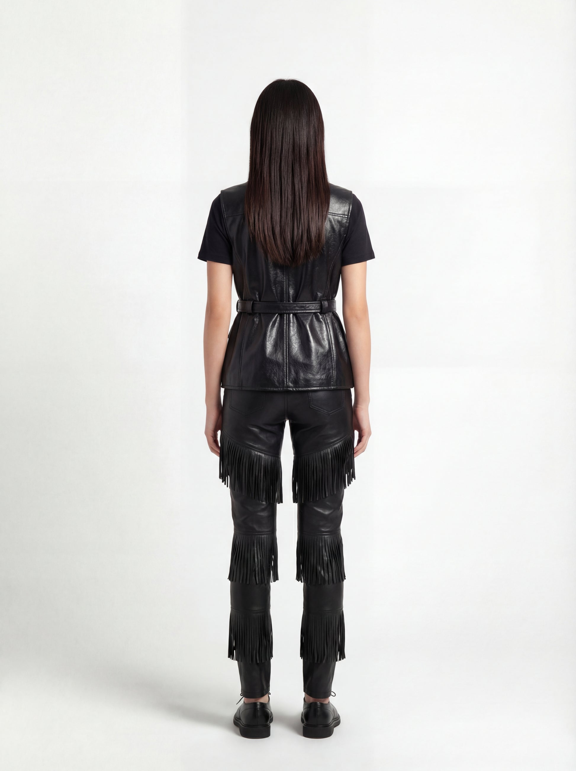Rear view of female model wearing Maverick Victoria utility vest showing sleek back fit and belted waist styling. Maverick Jacket.
