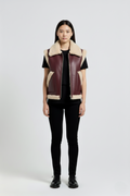 Female model wearing Maverick Clara shearling vest, relaxed fit, styled with black skinny trousers and black leather derby shoes. Maverick Jacket.