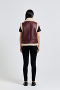 Rear view of female model wearing Maverick Clara shearling vest showing wide shoulder fit and straight back styling. Maverick Jacket.