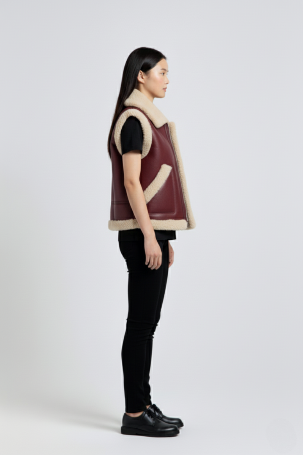 Side profile of Maverick Clara shearling vest showing shearling-trimmed armholes and boxy silhouette. Maverick Jacket.