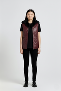 Female model wearing Maverick Isabelle quilted vest, fitted silhouette, styled with black t-shirt and black skinny trousers. Maverick Jacket.