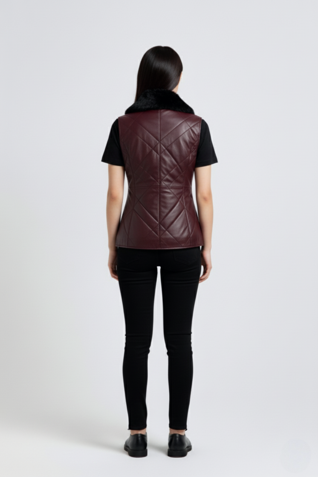 Rear view of female model wearing Maverick Isabelle quilted vest showing tailored waist fit and diamond stitched back styling. Maverick Jacket.