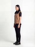 Side profile of Maverick Valentina shearling vest showing sleeveless structure and fitted waist-length silhouette. Maverick Jacket.