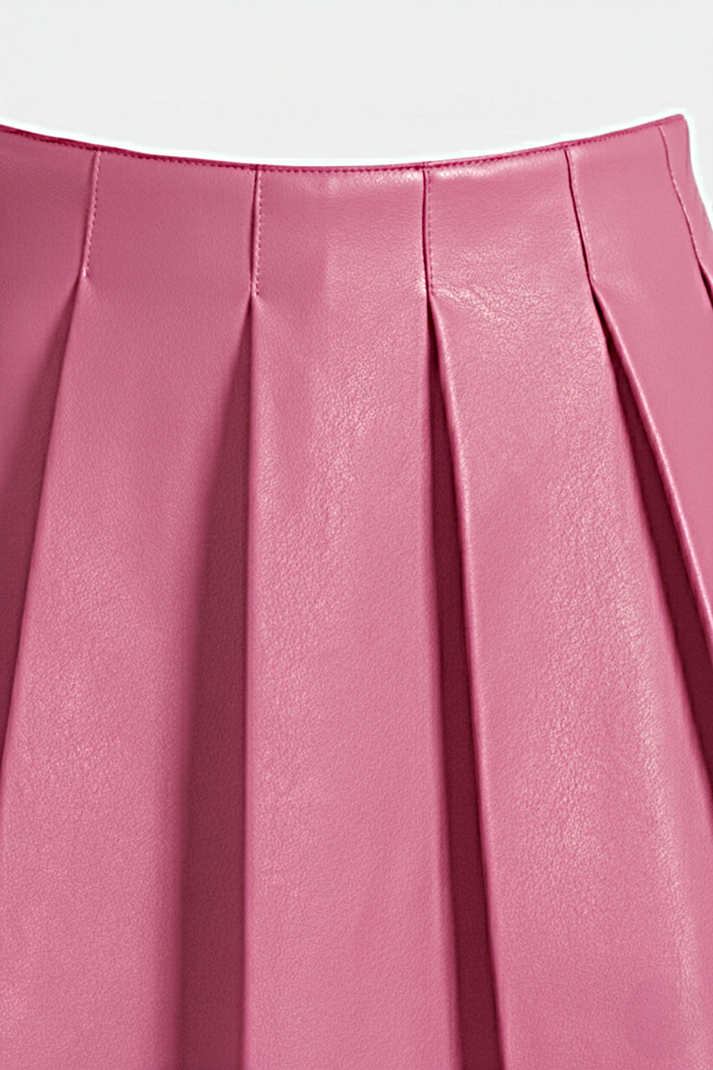 Macro shot of smooth pink leather grain and structured knife pleat detailing on skirt. The Poppy by Maverick Jacket.