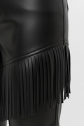Macro shot of smooth black leather texture and precision-cut fringe detailing on pants. The Stevie by Maverick Jacket.