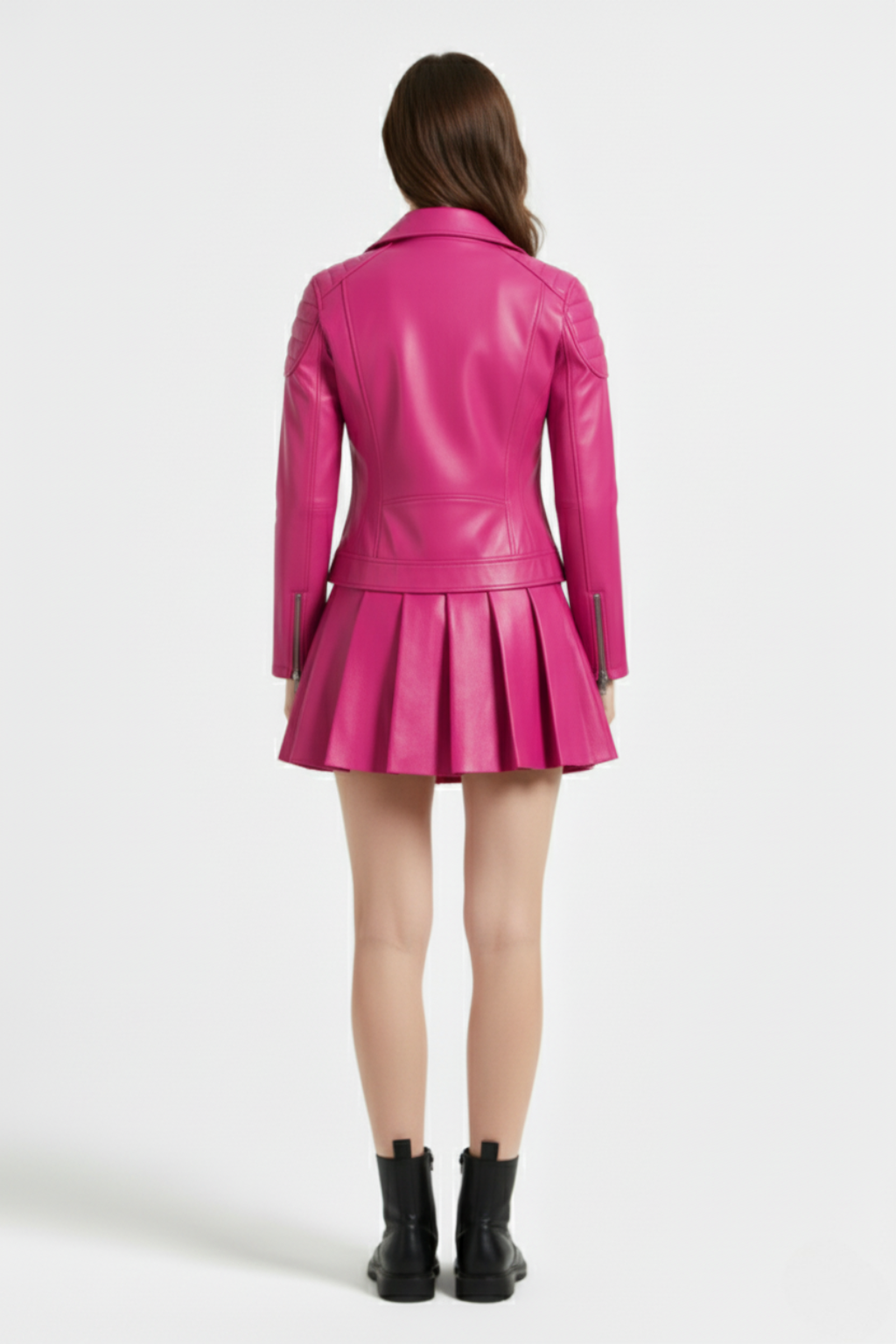 Rear view of female model wearing Maverick Poppy pleated leather skirt showing fitted waistband and flared back pleats. Maverick Jacket.