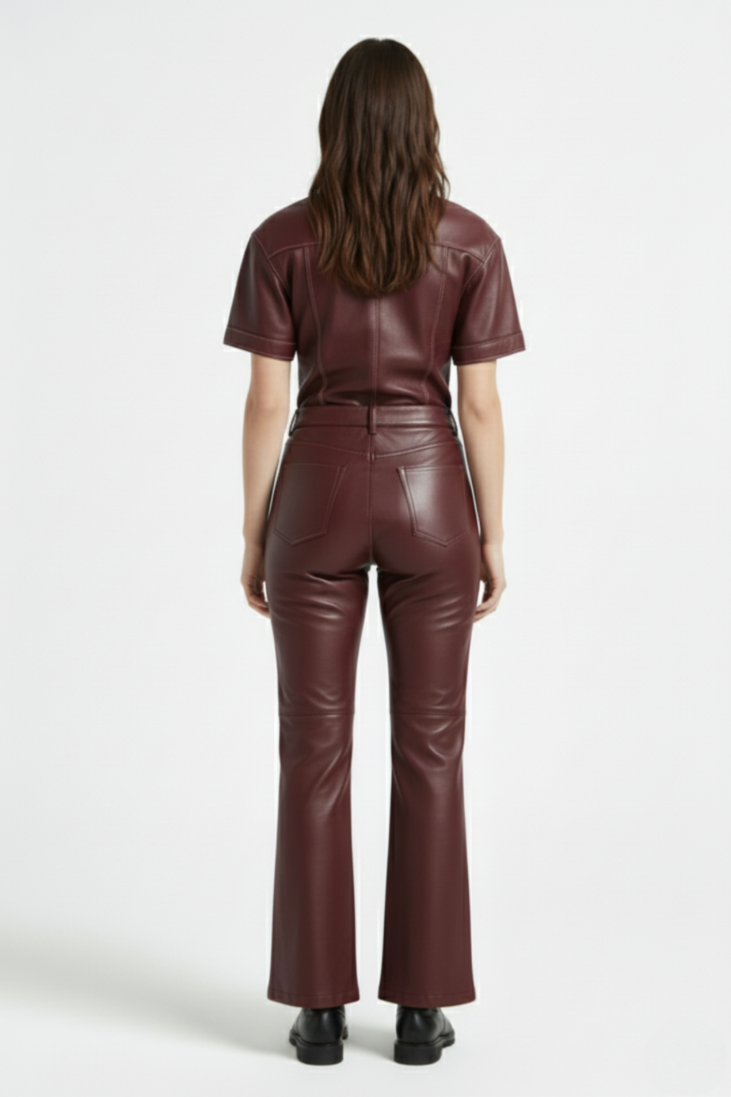 Rear view of female model wearing Maverick Bianca leather flare pants showing fitted seat and bootcut leg styling. Maverick Jacket.