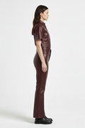 Side profile of Maverick Bianca leather flare pants showing clean side seams and flared silhouette. Maverick Jacket.