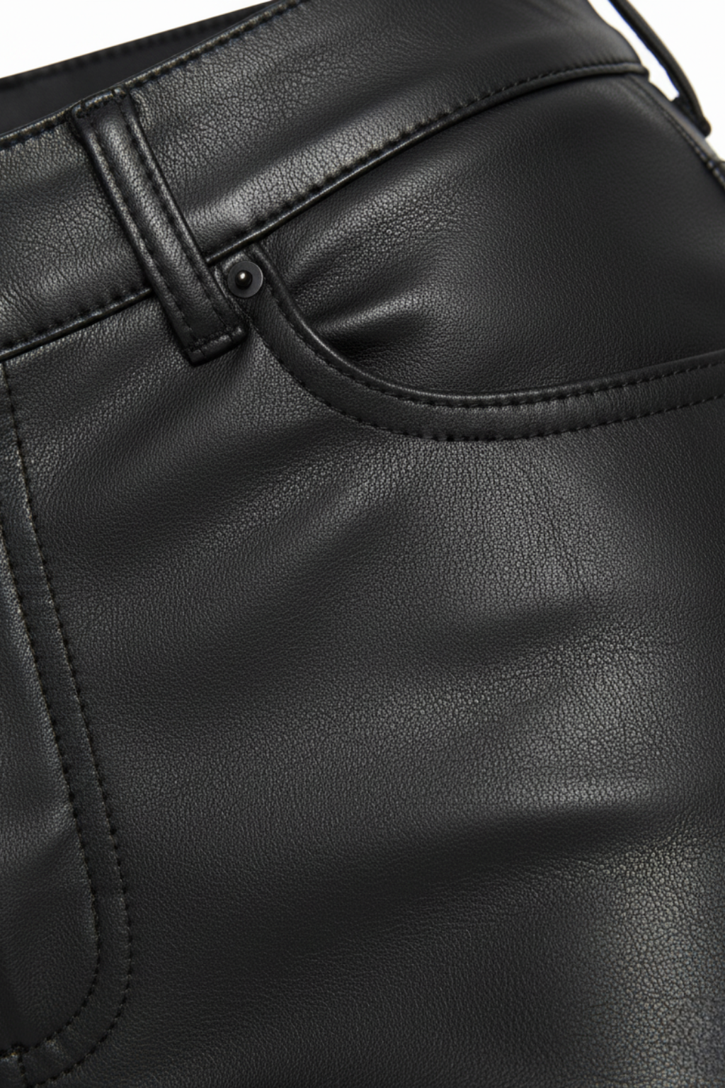 Macro shot of black leather grain and pocket stitching detail on flare pants. The Bianca by Maverick Jacket.