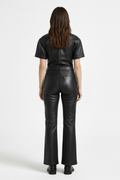 Rear view of female model wearing Maverick Bianca leather flare pants showing fitted seat and bootcut leg styling. Maverick Jacket.