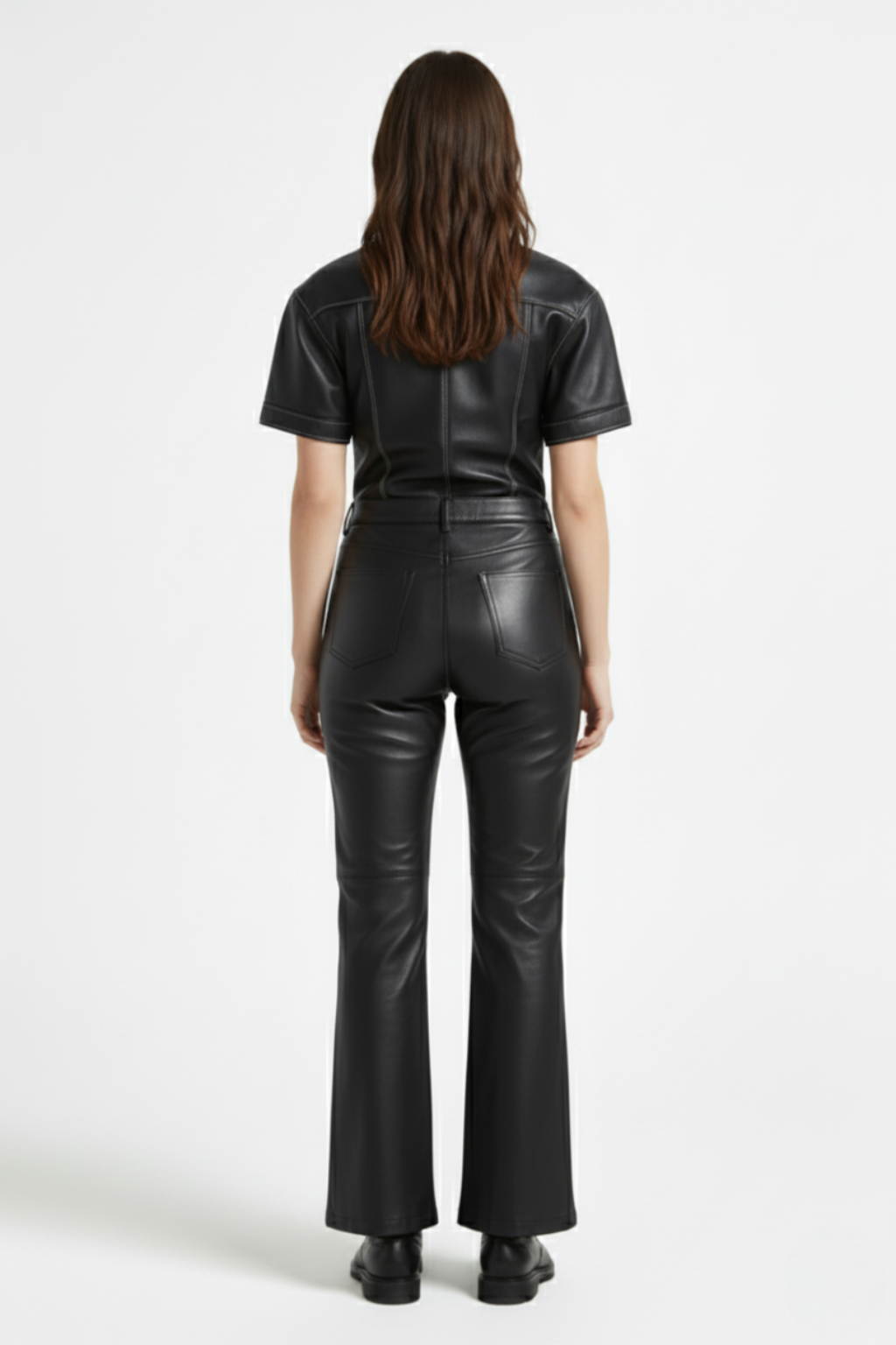 Rear view of female model wearing Maverick Bianca leather flare pants showing fitted seat and bootcut leg styling. Maverick Jacket.