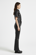 Side profile of Maverick Bianca leather flare pants showing clean side seams and flared silhouette. Maverick Jacket.
