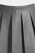Macro shot of smooth grey leather grain and structured knife pleat detailing on skirt. The Poppy by Maverick Jacket.