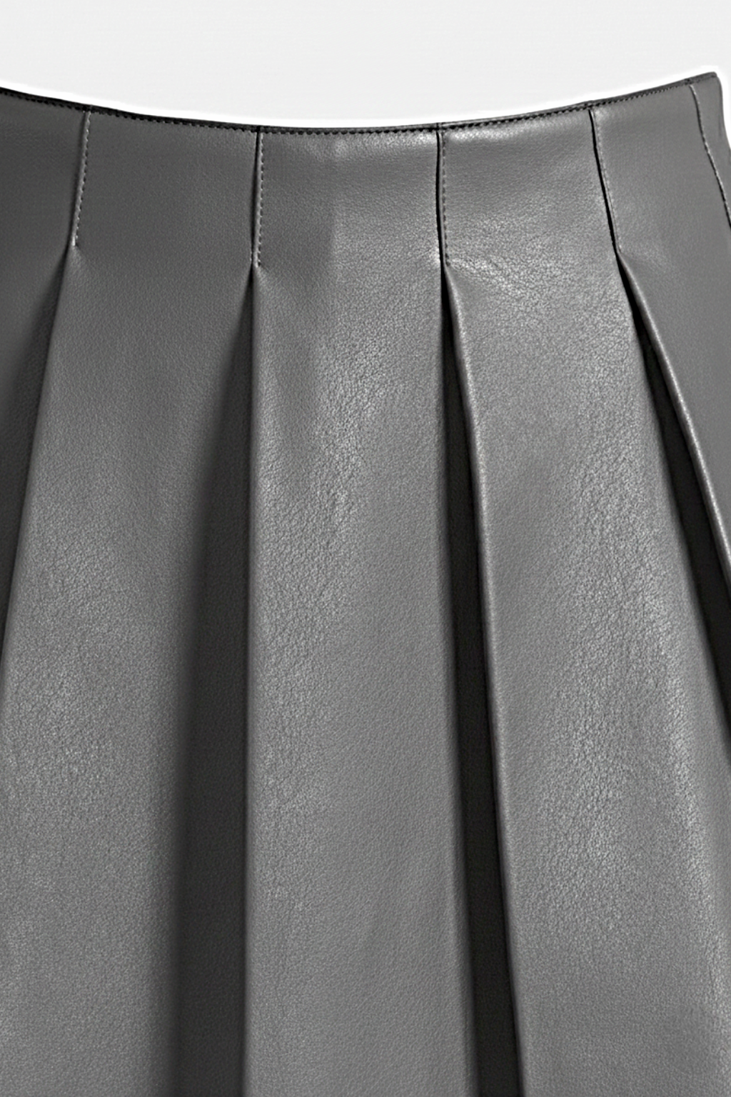 Macro shot of smooth grey leather grain and structured knife pleat detailing on skirt. The Poppy by Maverick Jacket.