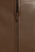 Macro shot of pebbled brown leather texture and discreet zipper closure on mini skirt. The Orla by Maverick Jacket.