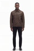 Front view of male model in Maverick Conroy brown leather sport jacket, black crewneck and denim; hem meets waist.