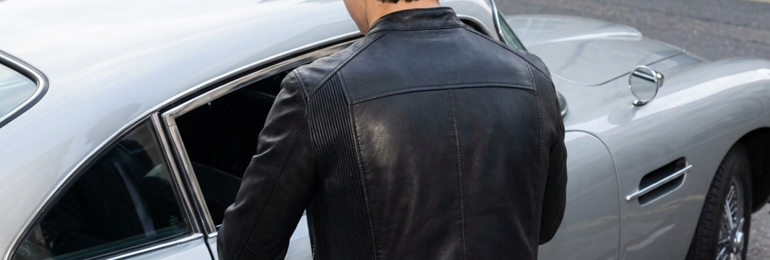Person in a black leather jacket getting into a silver car