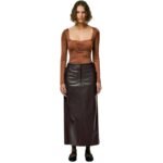 Model walking outdoors in a high-waisted brown leather skirt